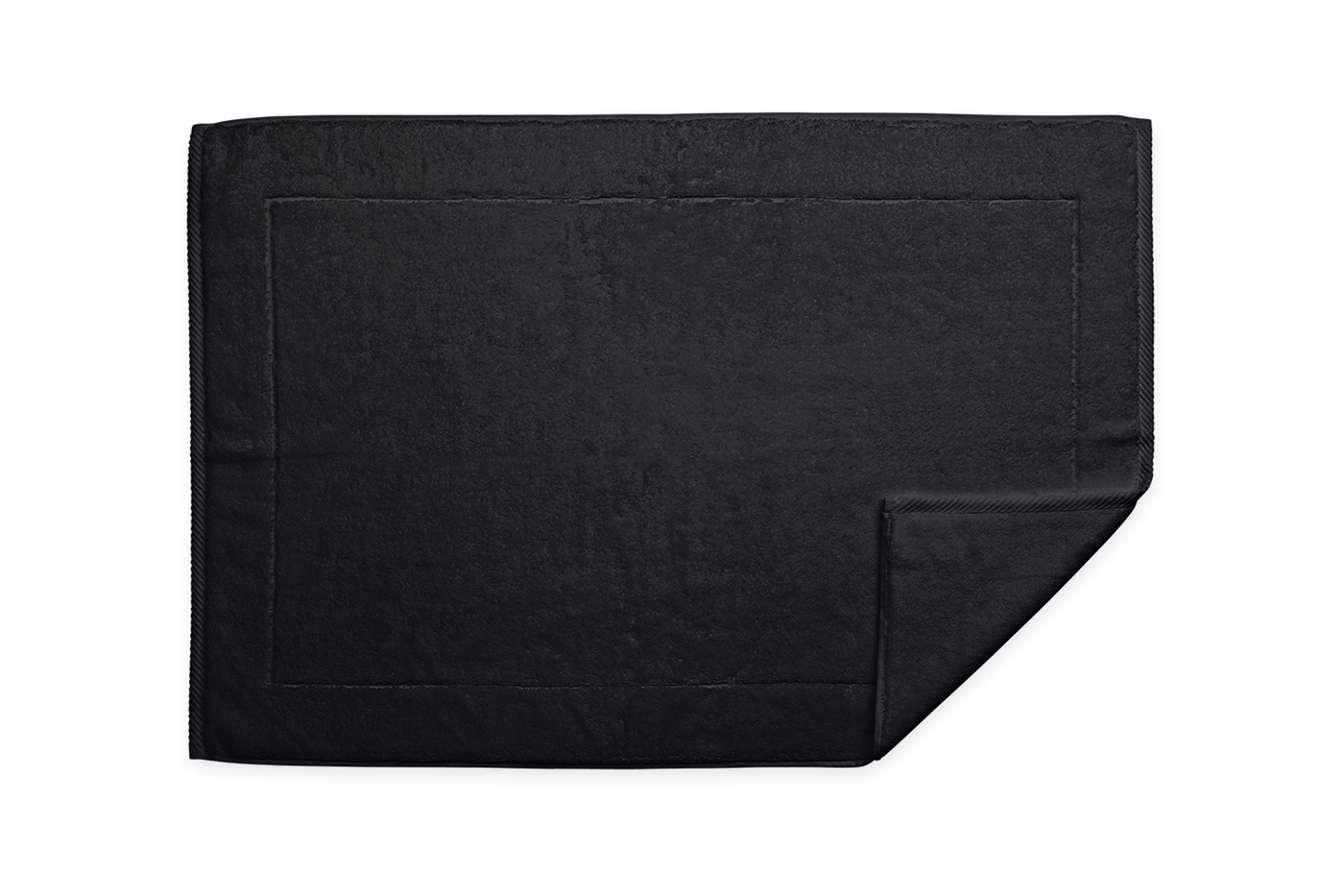 Corner detail of Matouk Milagro tub mat in black with folded edge visible.