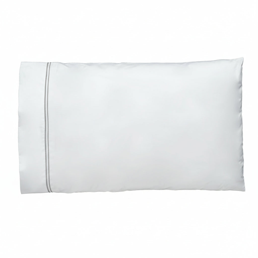Close-up of white pillowcase with delicate grey double-line embroidered border detail.