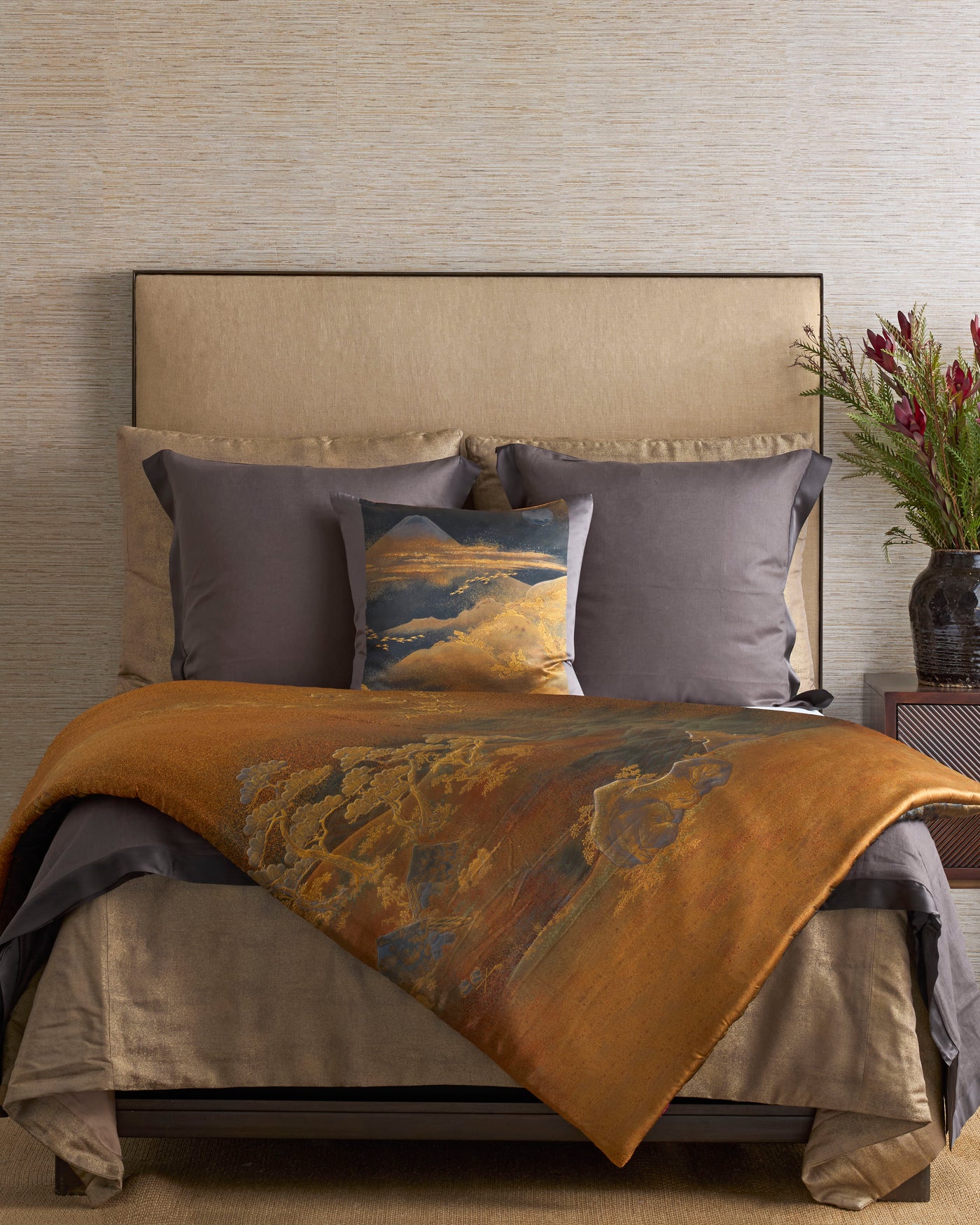 Mt. Fuji pillow styled on bed with amber throw and slate euro shams.