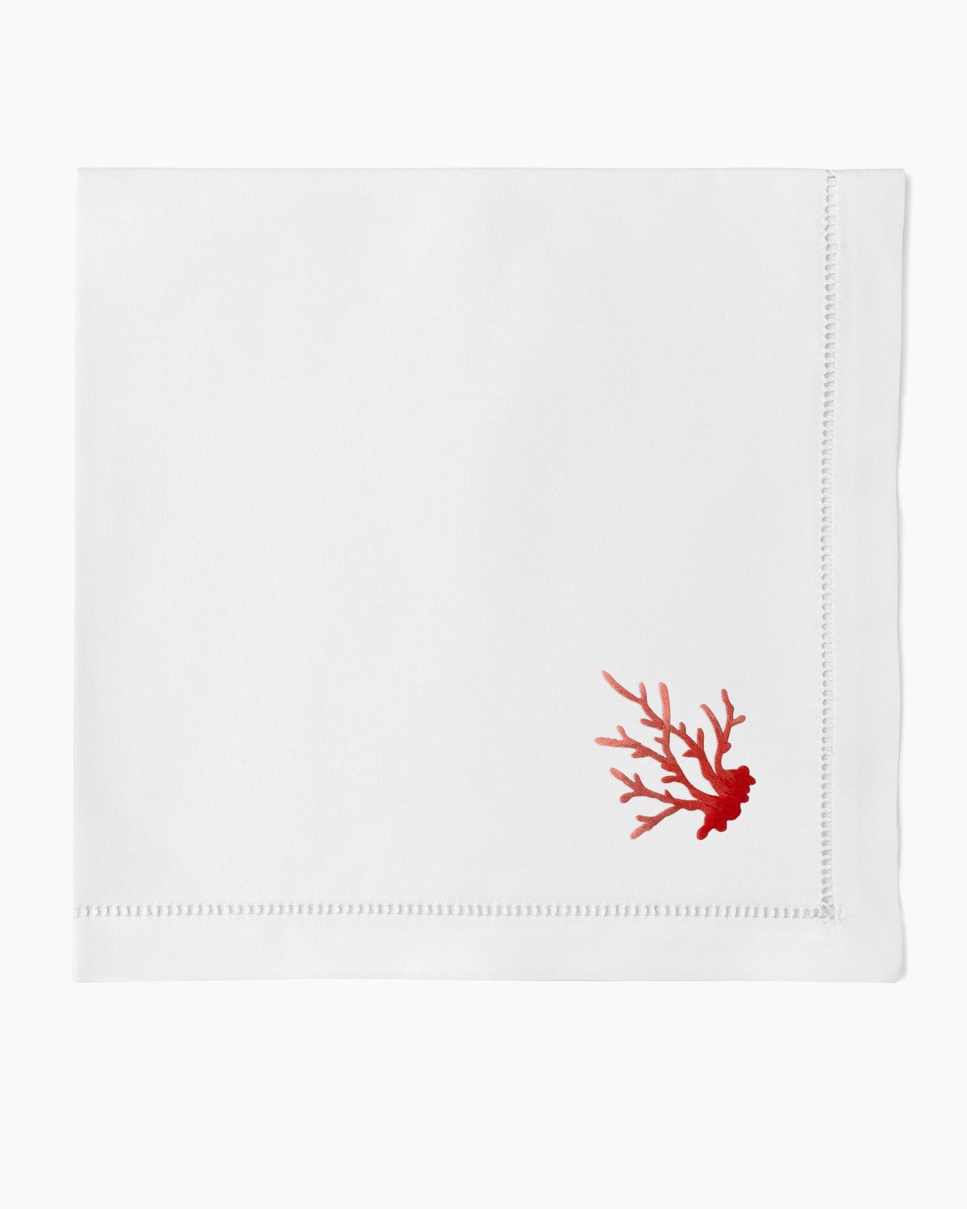 Henry Handwork white linen dinner napkin with red coral branch embroidery and hemstitch border.