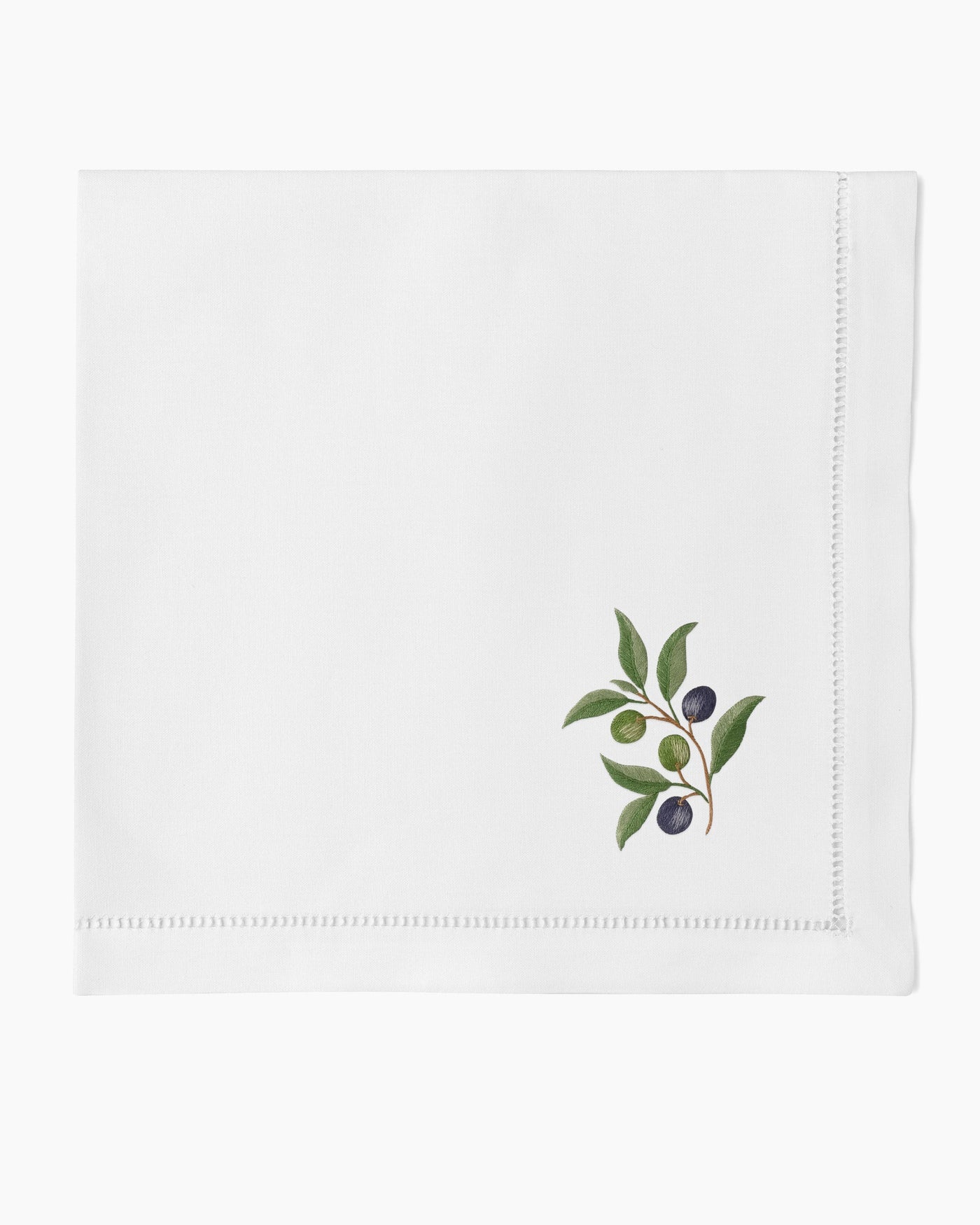 Henry Handwork white linen dinner napkin with embroidered olive branch motif and hemstitch border.