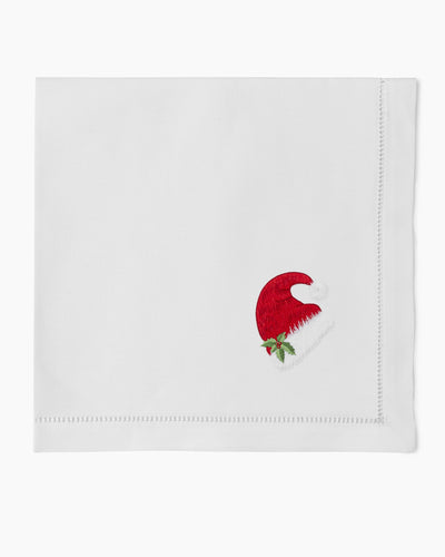 Henry Handwork white linen dinner napkin with embroidered red Santa hat and holly detail.
