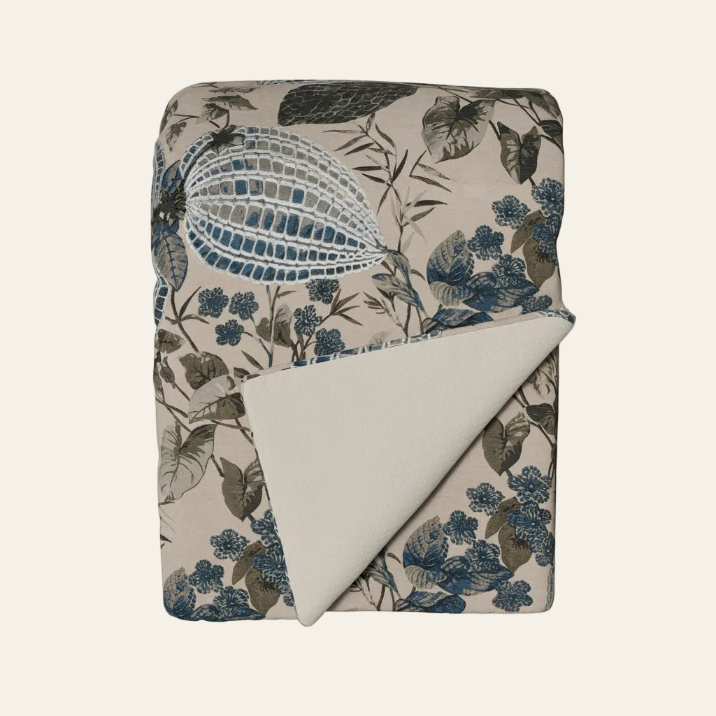 Ann Gish Nature throw in taupe and blue botanical print, folded to reveal ivory reverse.