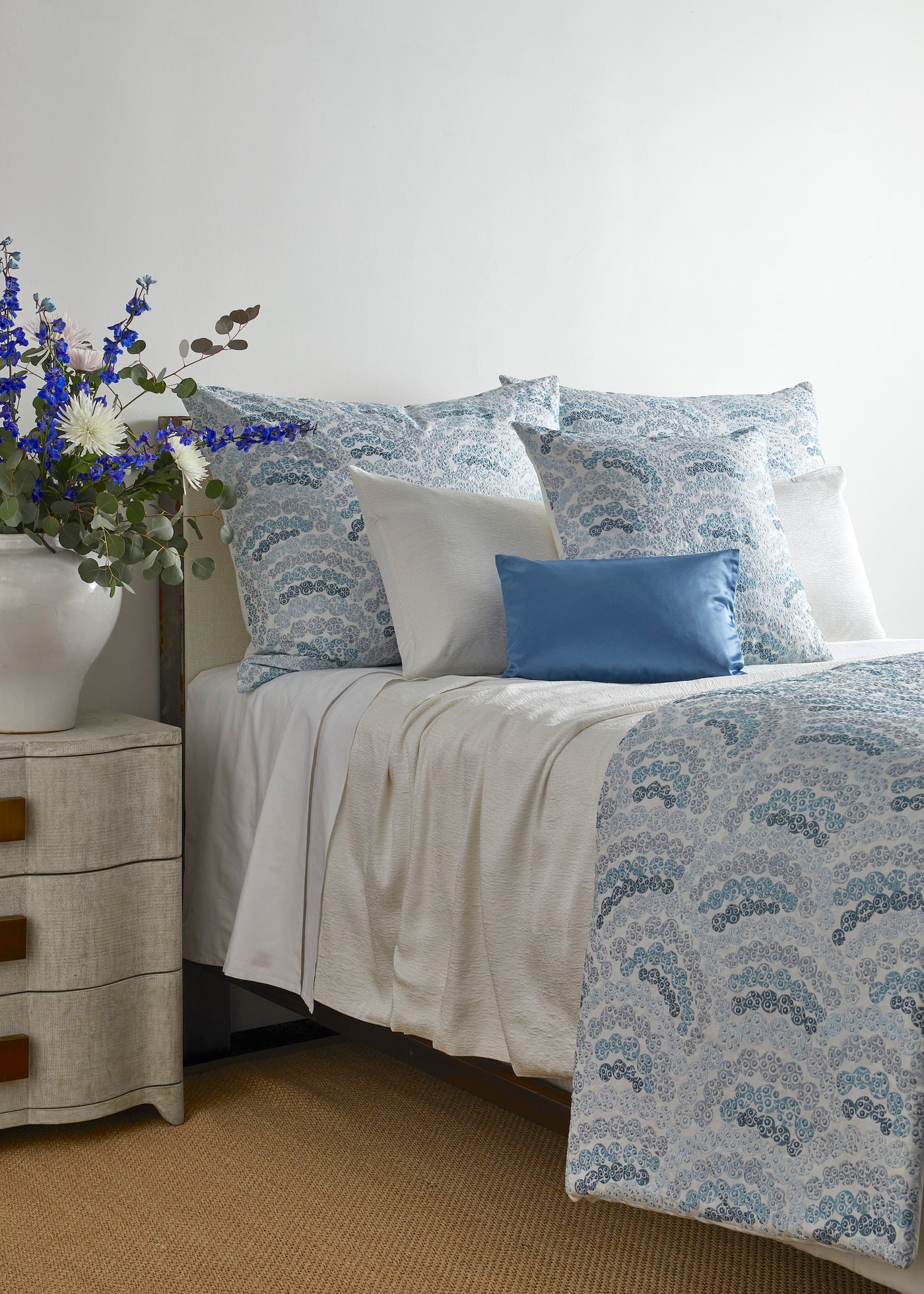 Bed styled with Ann Gish Nazar duvet in blue geometric pattern, with solid blue accent pillow.