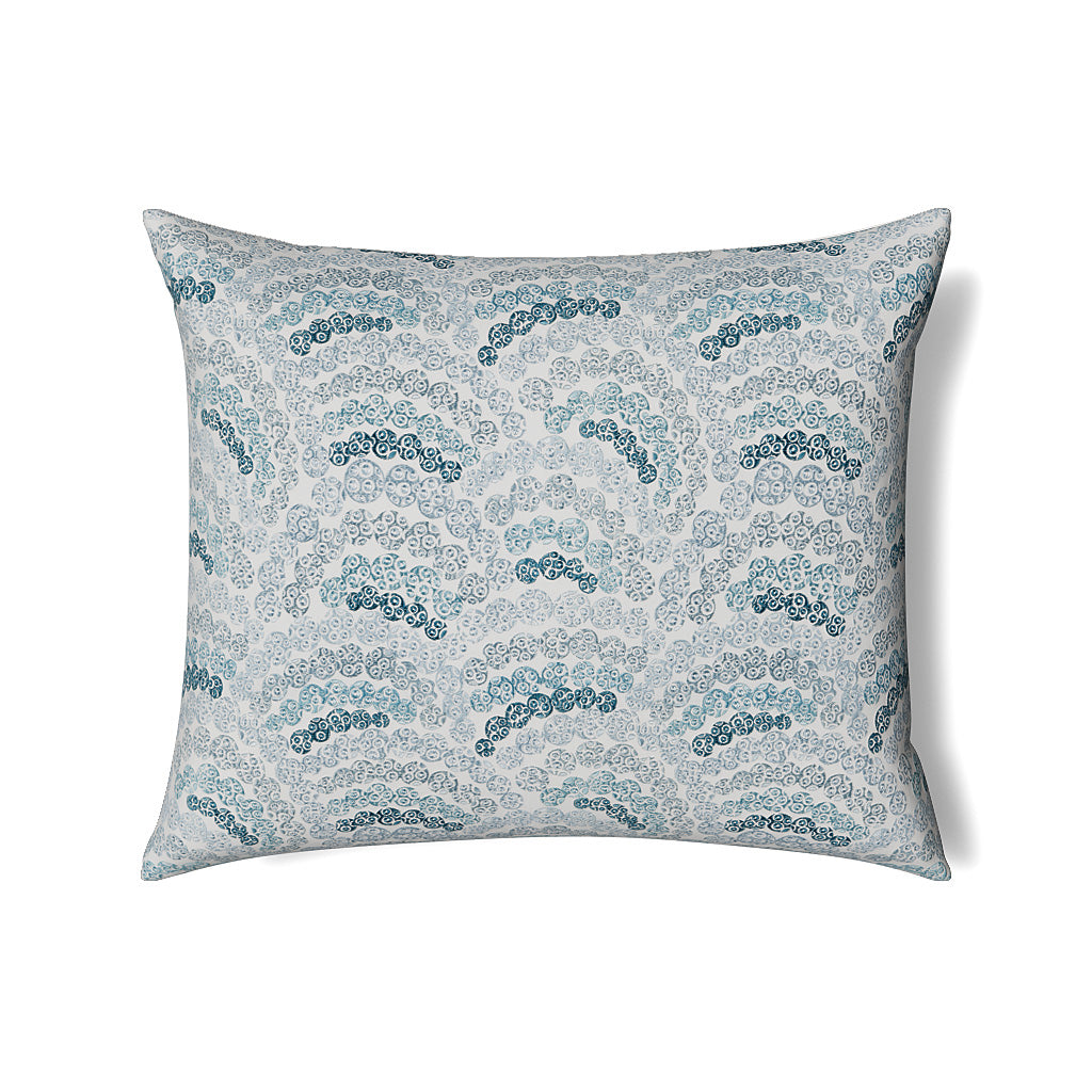 Teal and white evil eye pattern on a square pillow, side-angle view showing full shape.