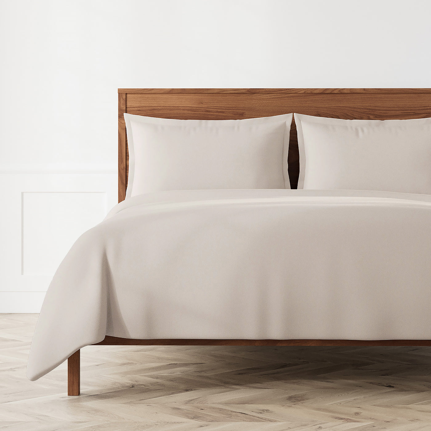 Ann Gish Neo duvet set in linen, styled on a wood-frame bed with matching shams.