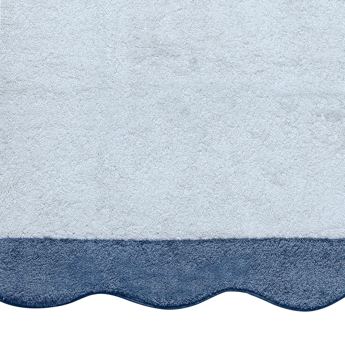The Matouk Neptune Pool Towel is a light blue textured Cairo cotton towel with a dark blue scalloped edge—an absorbent and stylish choice for the pool.