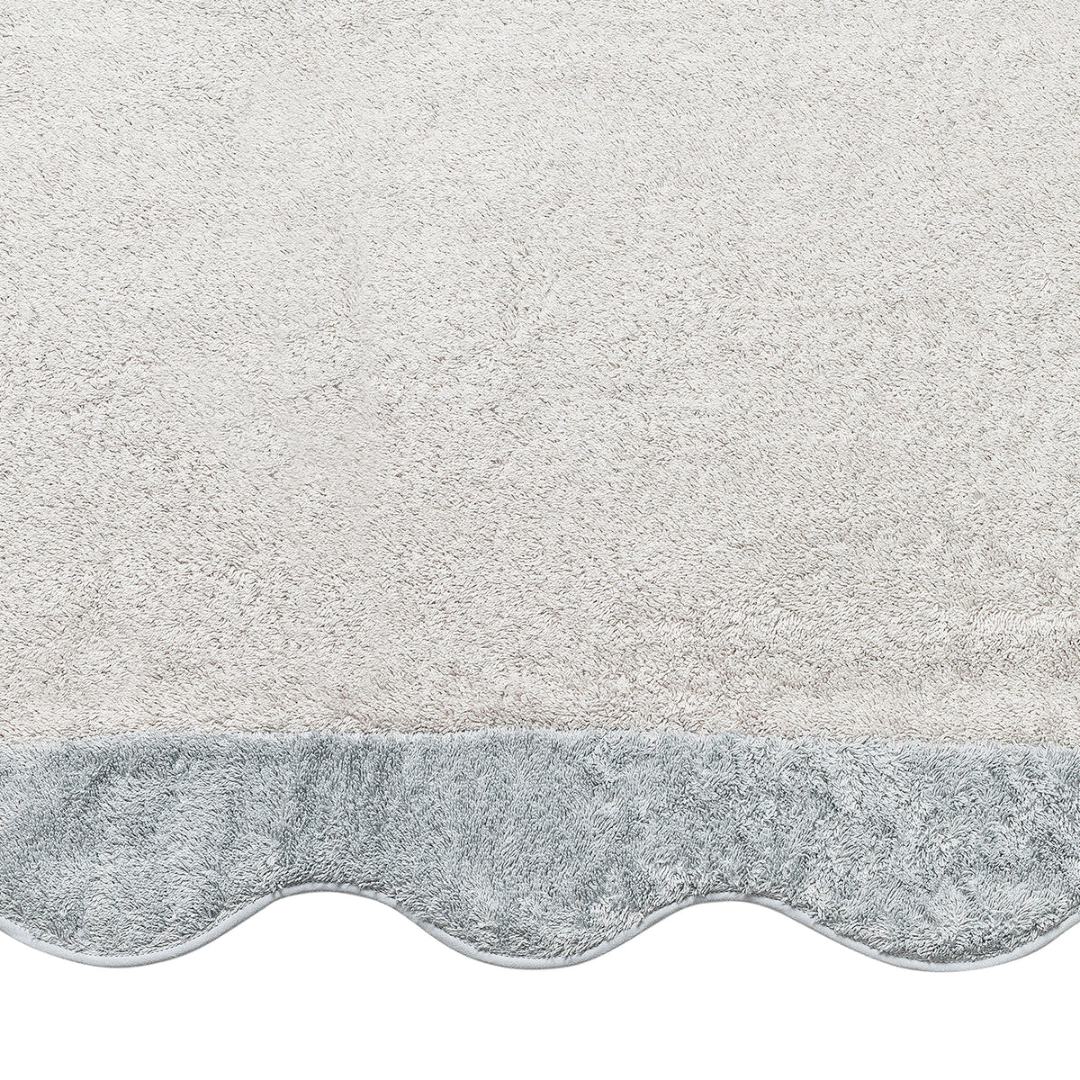 The Neptune | Pool Towel by Matouk, in white with a light gray scalloped edge and plush Cairo cotton texture, is photographed from above on a plain background.