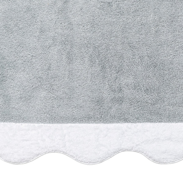 The Neptune | Pool Towel by Matouk is a light gray Cairo cotton towel with a white scalloped edge, shown close-up to showcase its soft texture, absorbent quality, and elegant border.