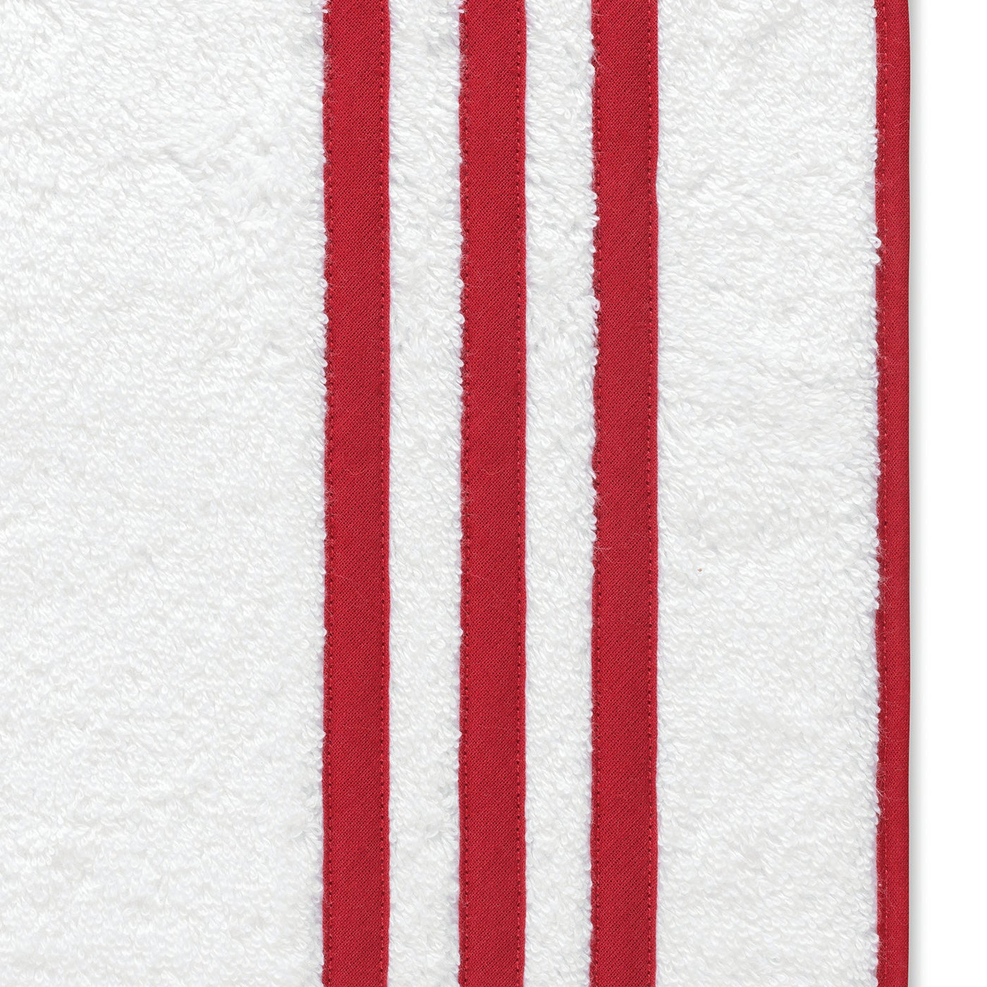 Close-up of white diamond pique fabric with three vertical red stripes at left—ideal for adding texture to your Matouk Newport Shower Curtain.