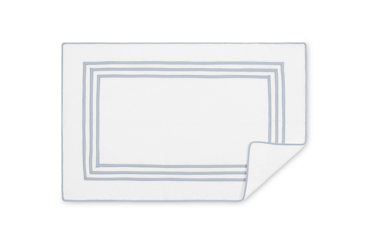 Corner fold detail of Matouk Newport tub mat showing layered silver border framing on white.