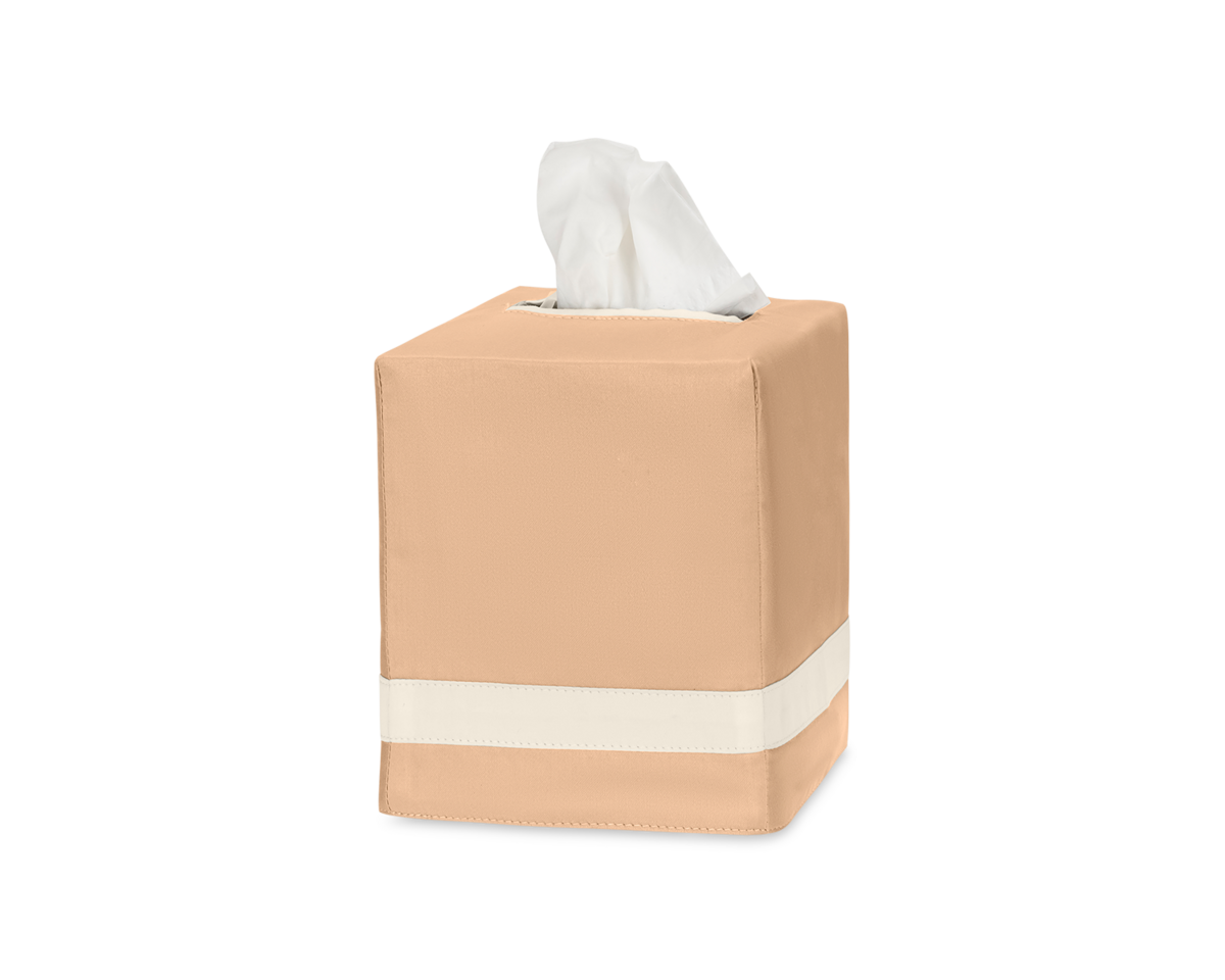 The Matouk Nocturne Tissue Box Cover in tan features a white horizontal stripe near the base and holds tissues neatly, blending effortlessly with your home decor.
