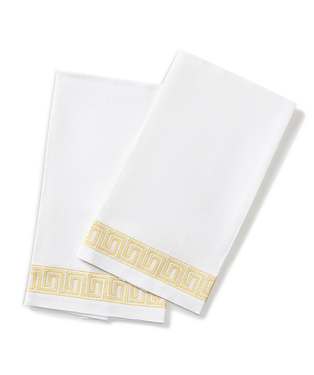 The Ophelia | Embroidered Guest Towel Set by Matouk features two white towels with a gold Greek key accent—ideal as luxury bathroom towels or elegant embroidered linen decor for any space.
