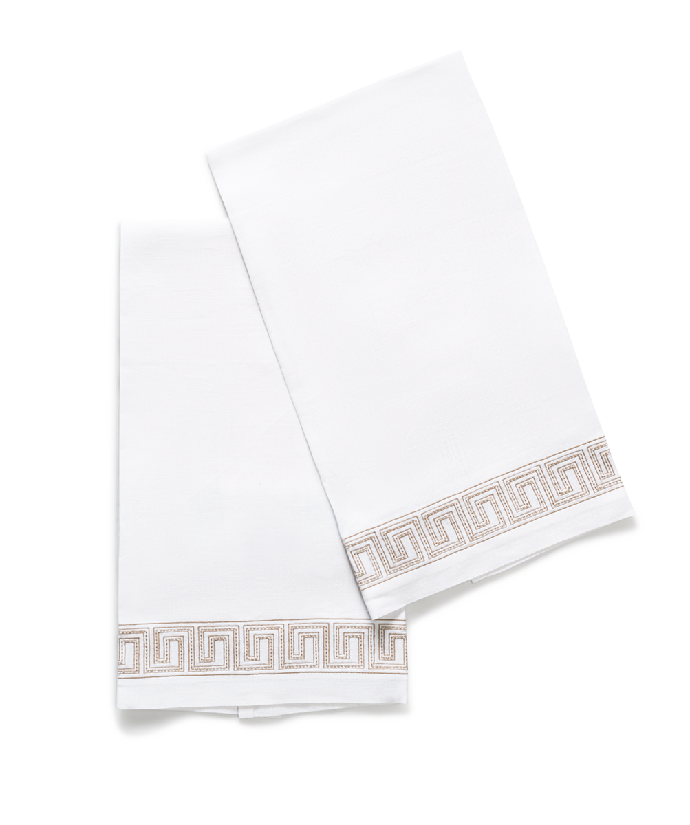 The Ophelia Embroidered Guest Towel Set by Matouk features two white rectangular towels with a beige Greek key pattern, displayed overlapping on a plain white background to enhance your luxury bathroom collection.