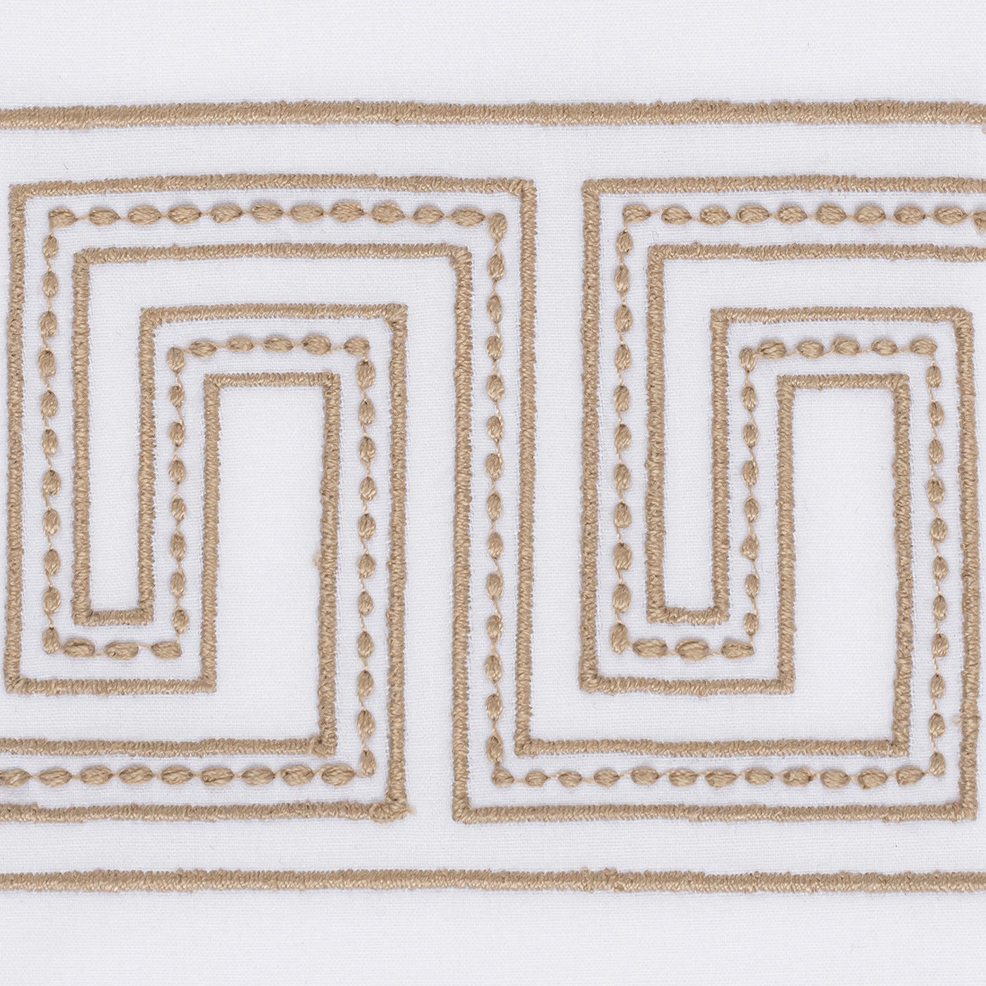 The Ophelia Embroidered Guest Towel Set by Matouk features white fabric with a repeating tan Greek key pattern in dotted stitching—perfect for adding luxury and elegance to your bathroom.