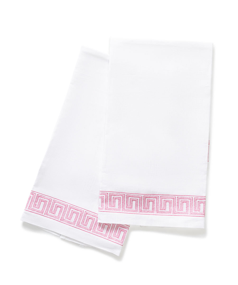 The Ophelia | Embroidered Guest Towel Set by Matouk features two white linen towels with pink Greek key borders, shown overlapping on a plain background—an elegant accent for any bathroom.