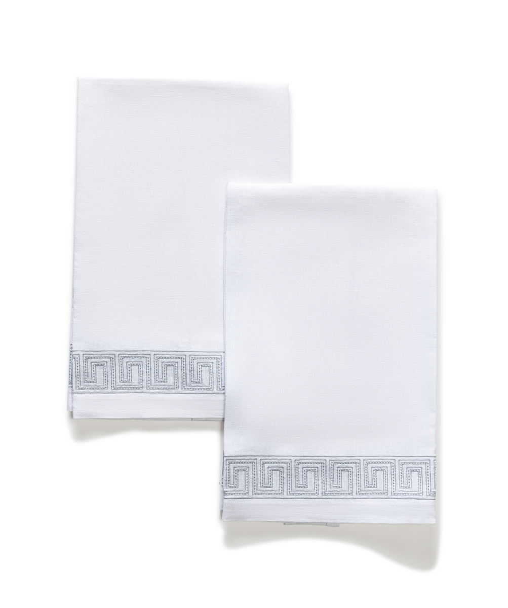 The Ophelia | Embroidered Guest Towel Set by Matouk features two white linen towels with a subtle light gray Greek key design—an elegant touch for any sophisticated setting.