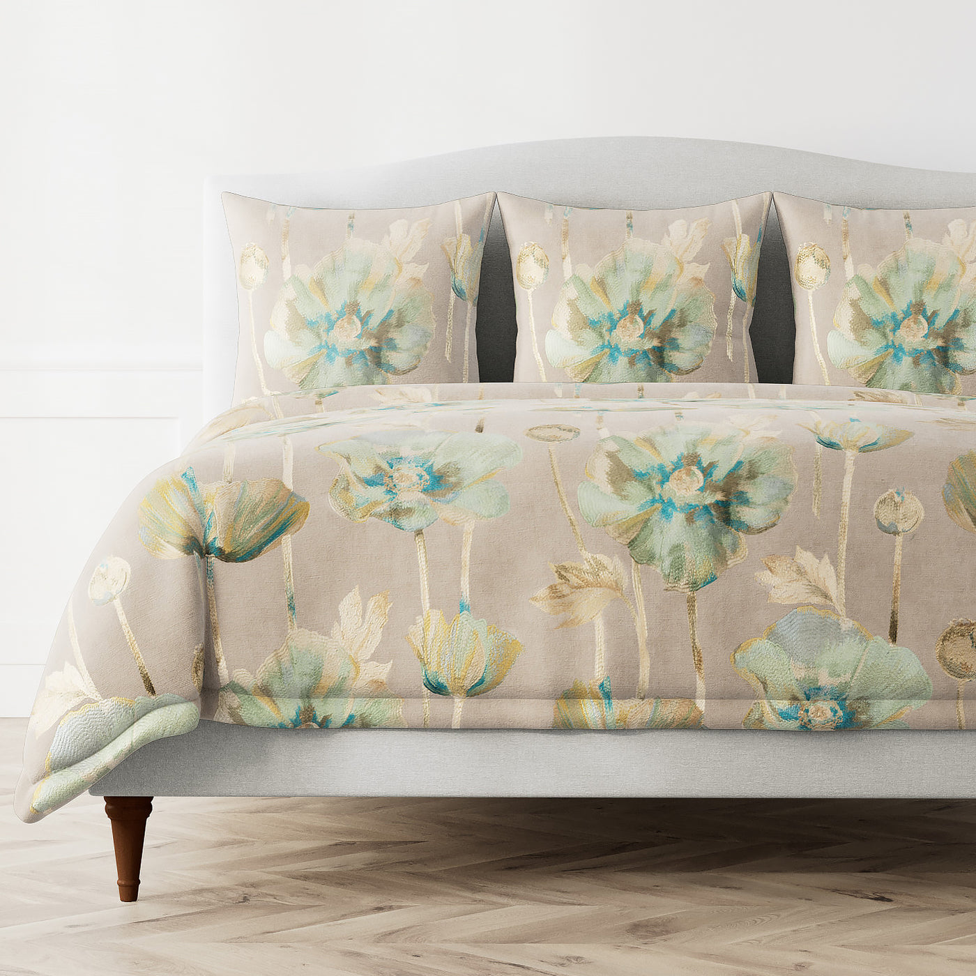 Ann Gish Opium duvet cover in blush with watercolor teal and gold floral print, styled on bed.