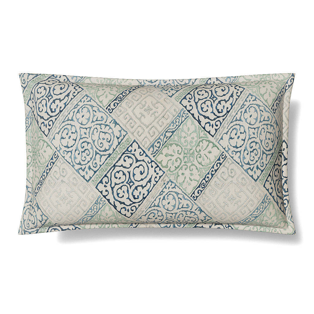 Close-up of Ann Gish Oporto sham with diamond tile print in slate blue and sage on ivory.