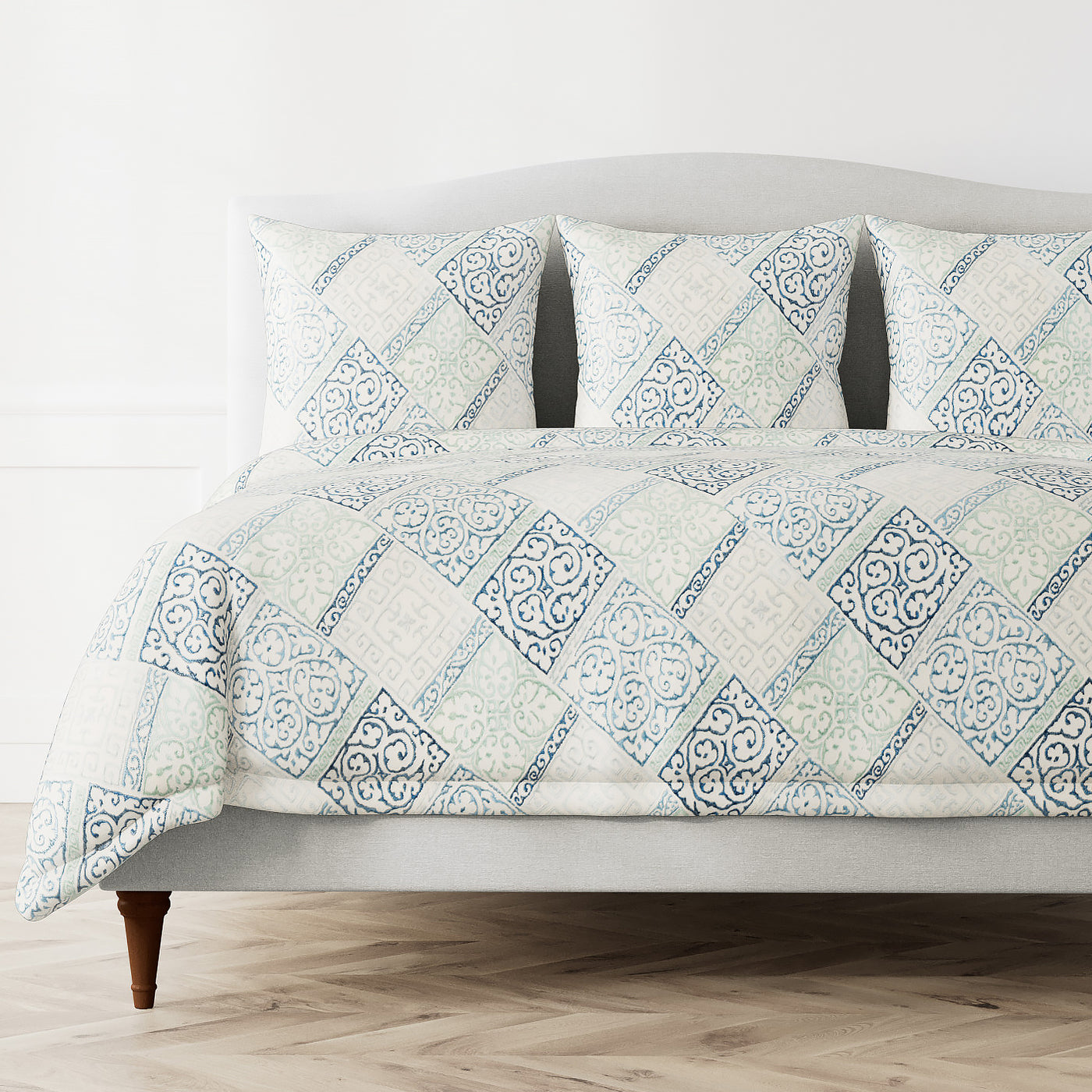 Ann Gish Oporto duvet cover in blue and ivory diamond tile pattern on styled bed.