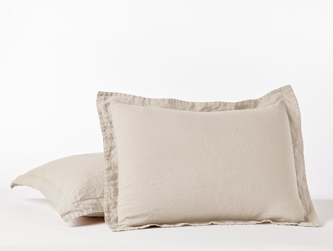 Close-up of Coyuchi Relaxed Linen pillow shams in natural, showing flanged edge detail.