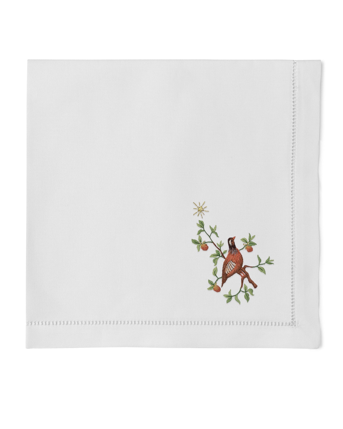 Henry Handwork Partridge Pear Tree white linen napkin with embroidered bird on branch.