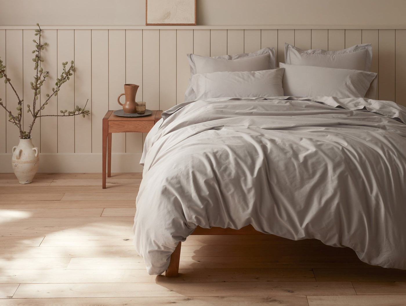 Close-up of Coyuchi Cloud Soft Sateen duvet cover in silver grey, relaxed drape on styled bed.
