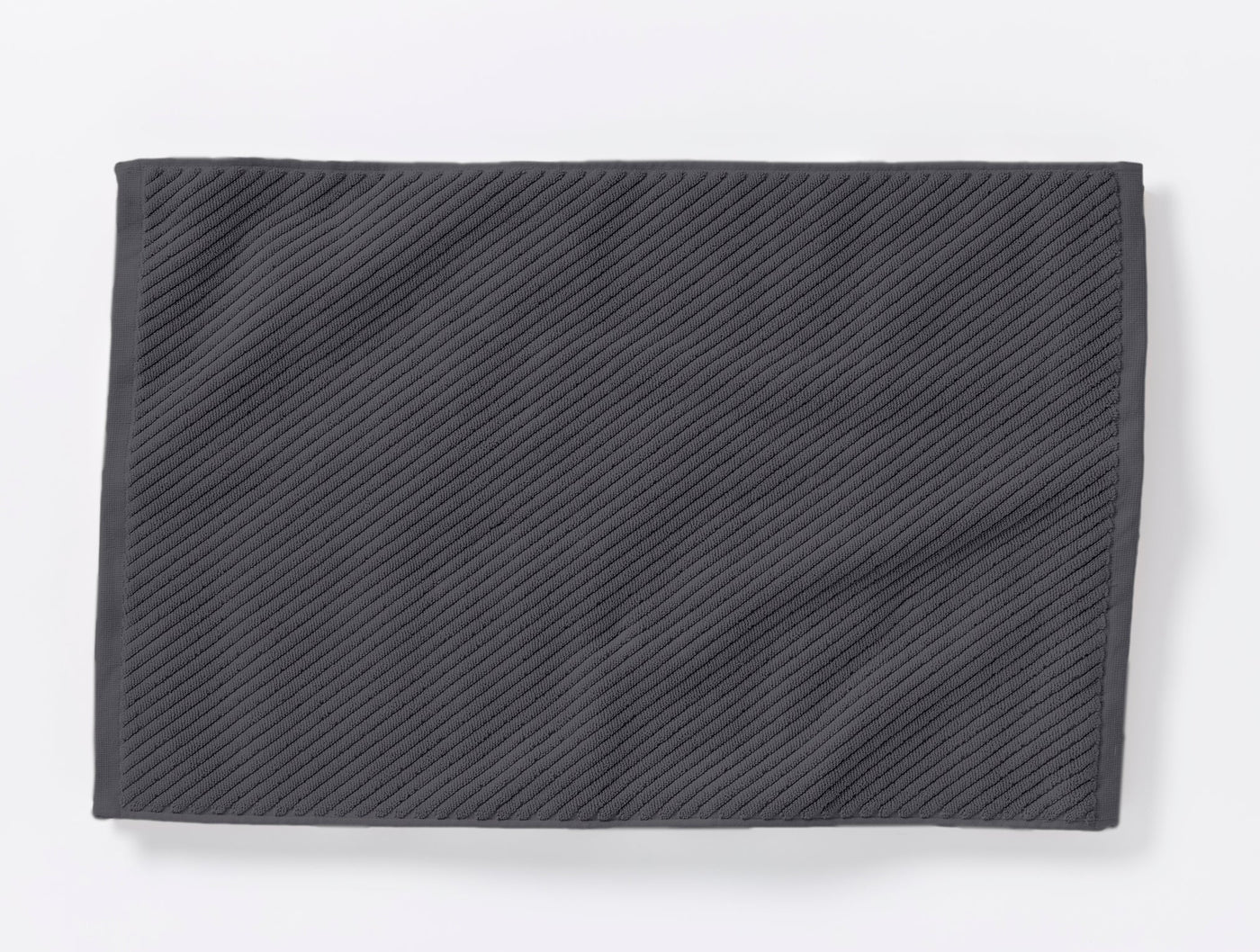 Slate grey twill-weave bath rug, flat lay showing diagonal ribbed texture.