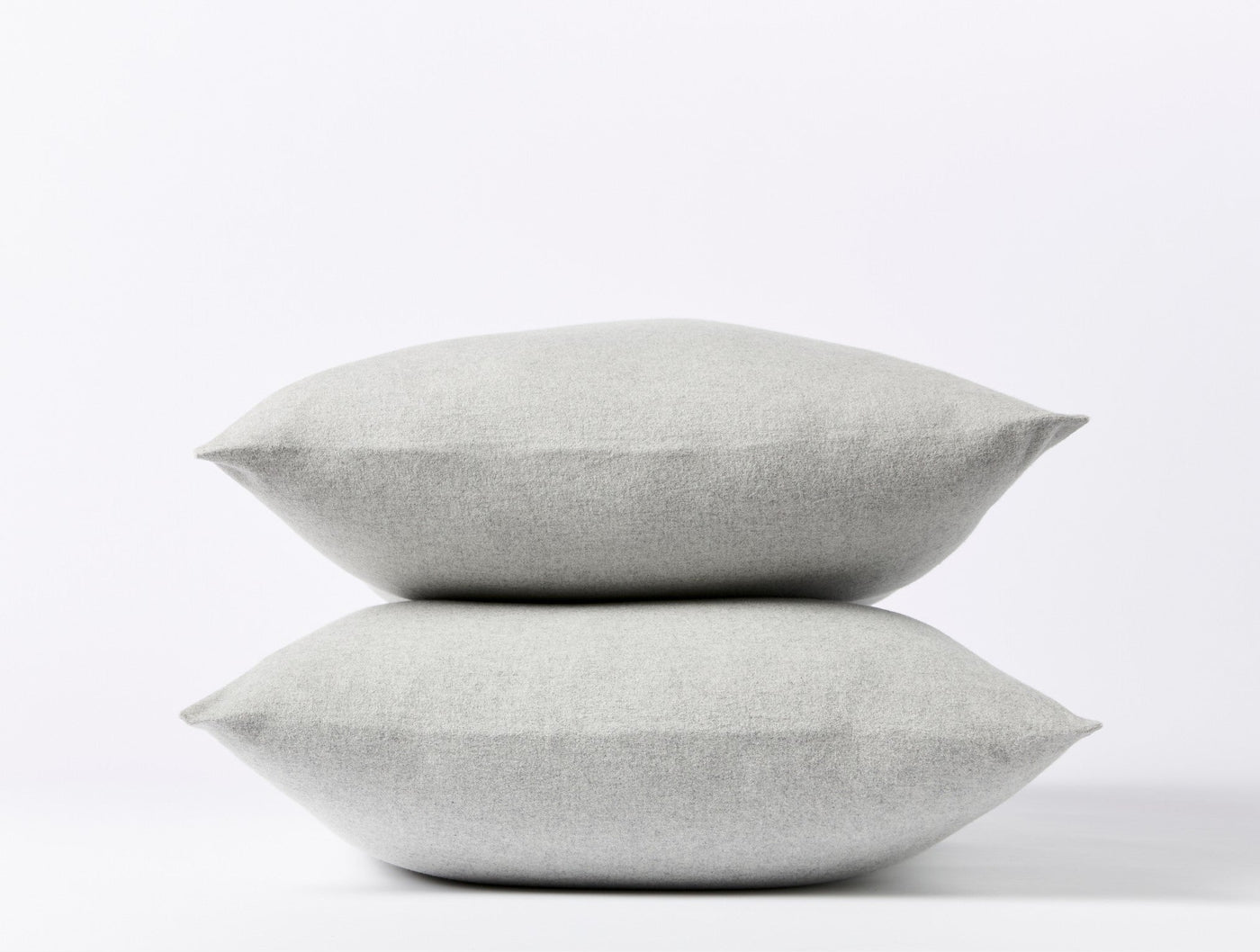 Two stacked Coyuchi Cloud Brushed Flannel pillowcases in silver mist, showing plush texture.