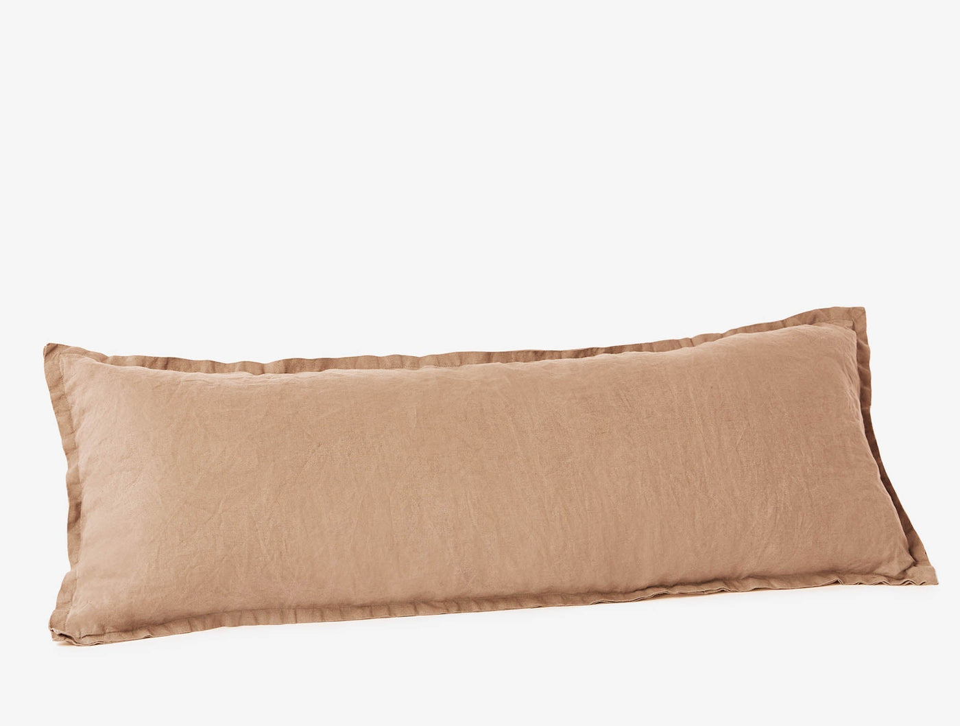 Coyuchi Relaxed Linen bolster pillow in warm terracotta, shown from a slight angle.