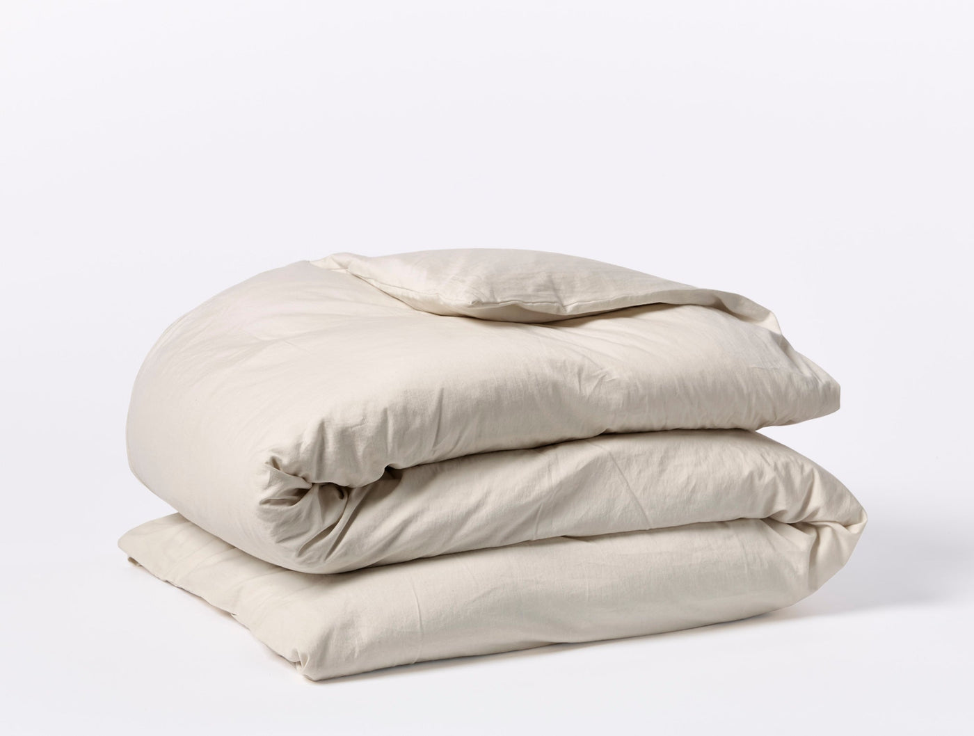 Coyuchi Cloud Soft Sateen duvet cover folded in parchment, showing smooth sateen finish.