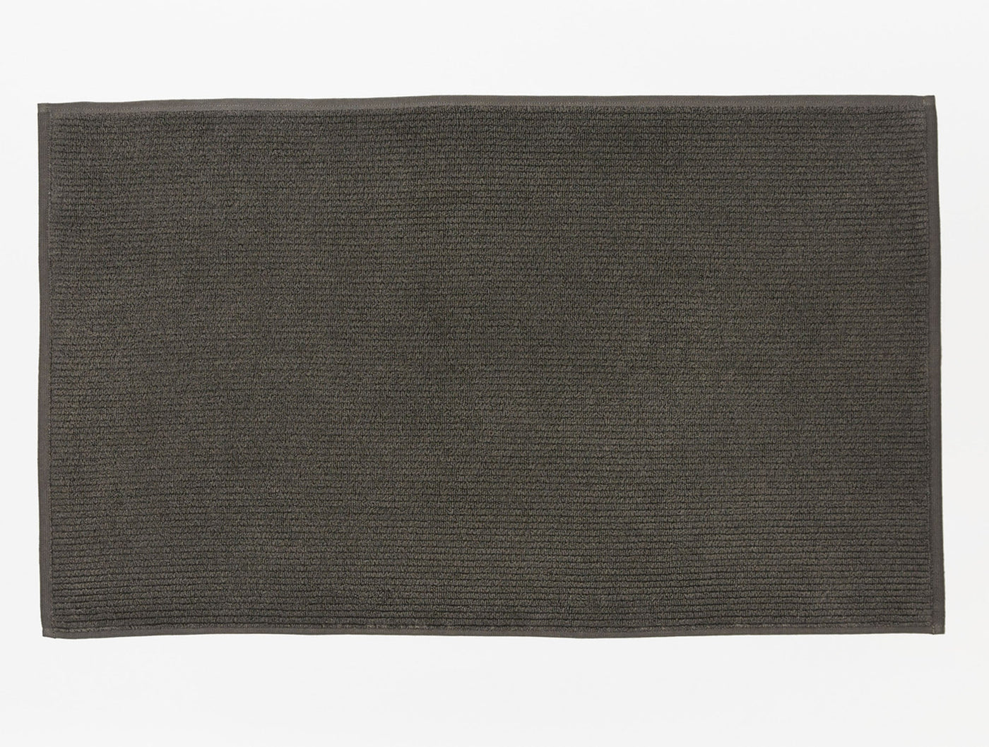 Coyuchi Temescal ribbed bath rug in charcoal, flat lay showing ribbed texture.