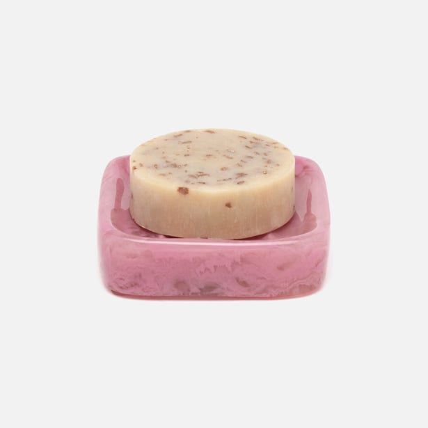 Pigeon & Poodle Abiko soap dish in pink resin with a round bar soap resting on top.