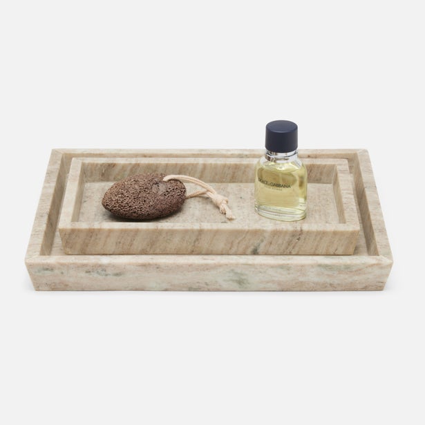 Pigeon & Poodle Athlone nesting tray set in beige travertine marble, styled with bath accessories.