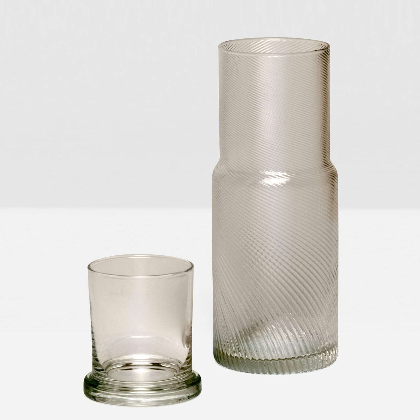 Pigeon & Poodle Banca carafe with ribbed glass texture, paired with a tumbler, in smoke.