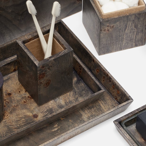 Dark burl wood bathroom accessories set with toothbrush holder, tray, and cotton jar displayed together.