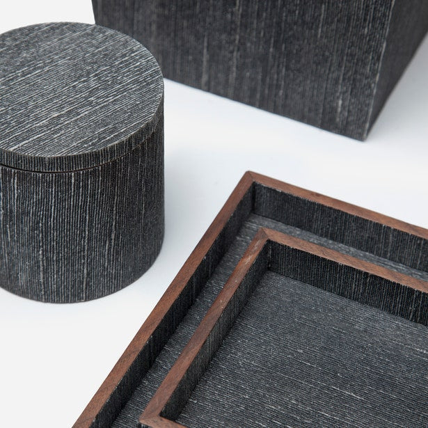 Close-up of charcoal textured bath accessories with wood-trimmed tray detail.