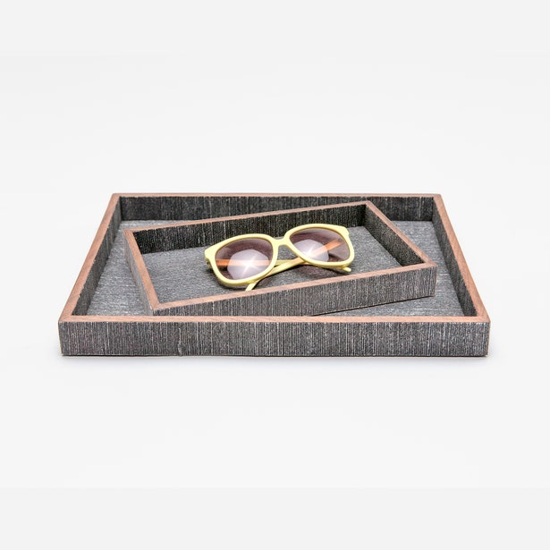 Pigeon & Poodle Bruges nesting tray set in charcoal raffia with copper trim, styled with sunglasses.