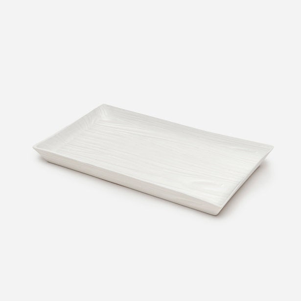 Pigeon & Poodle Burma tray in white with embossed wave texture, angled view.