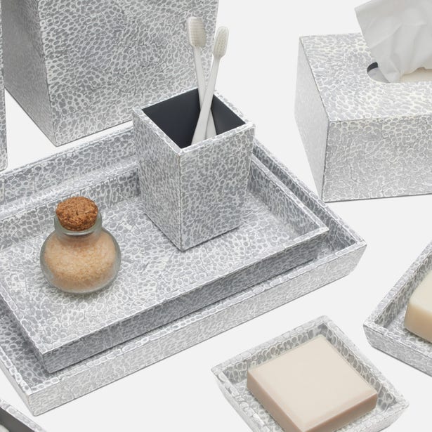Silver hammered-texture bath accessories set with trays, toothbrush holder, tissue box, and soap dish.