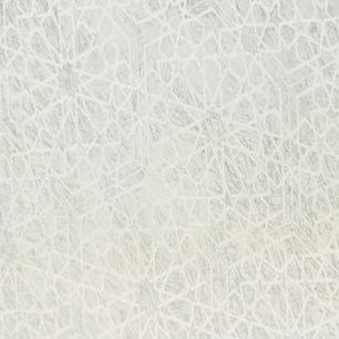 Close-up of an ivory geometric lace-like pattern on a textured white surface.
