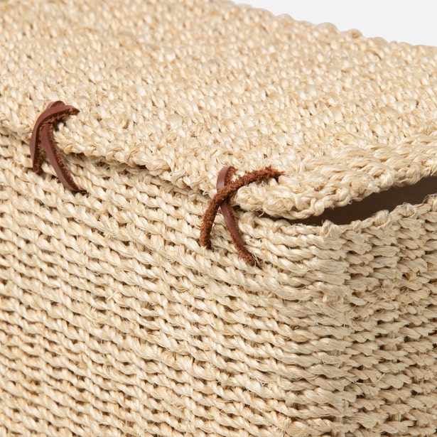 Close-up of natural woven texture and brown leather cord detail on Chelston toilet paper holder.