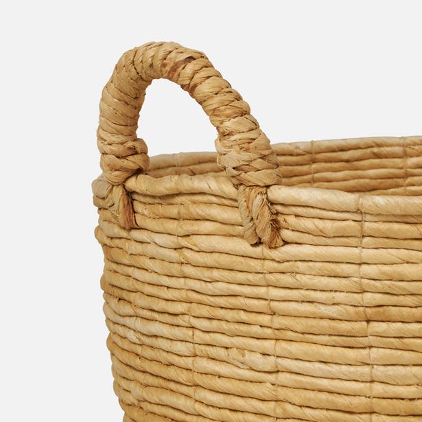 Close-up of Pigeon & Poodle Clio basket handle and woven natural fiber rim detail.