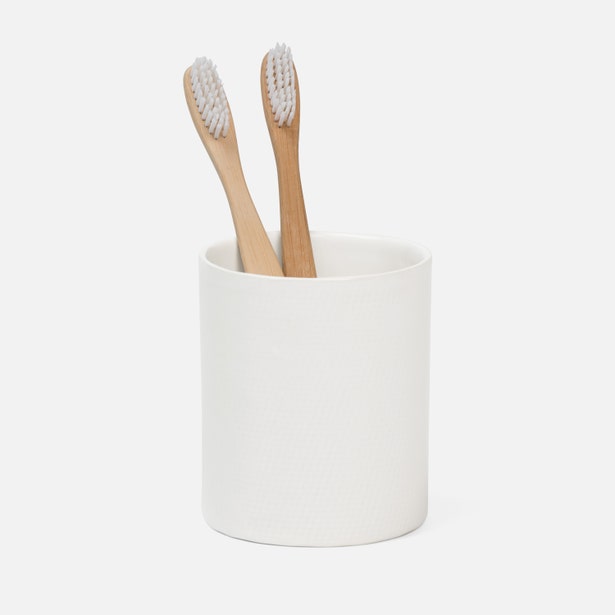 Pigeon & Poodle Cordoba brush holder in white with two bamboo toothbrushes.