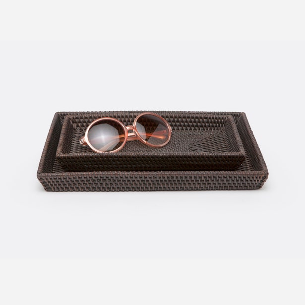 Pigeon & Poodle Dalton nesting tray set in dark brown rattan with rose-toned sunglasses styled on top.