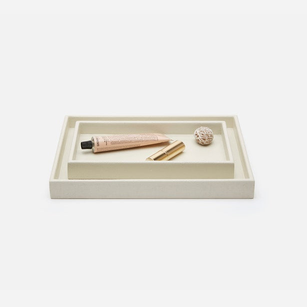 Pigeon & Poodle Dannes ivory nesting tray set styled with beauty accessories on white background.