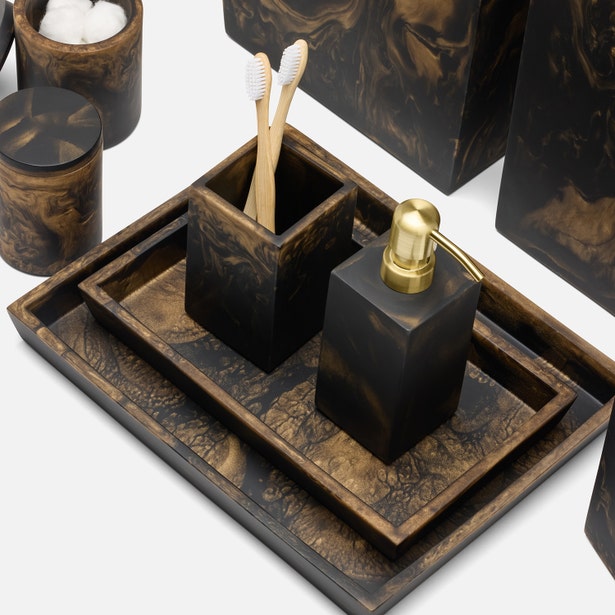 Pigeon & Poodle Duluth nesting trays styled with matching bath accessories in black and gold resin.