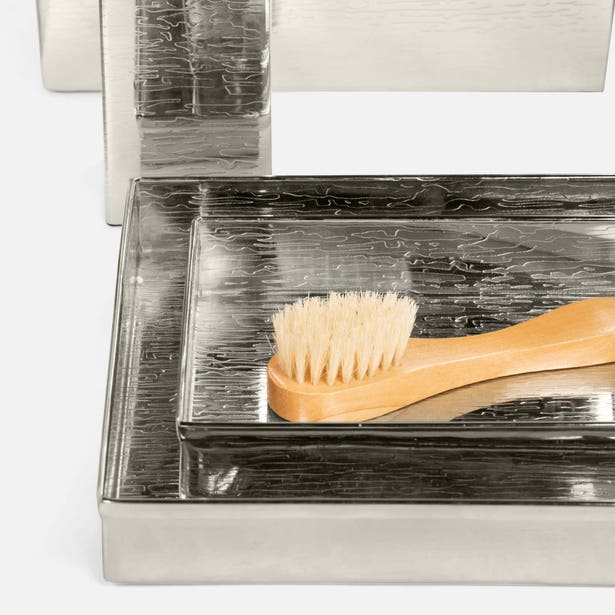 Close-up of Pigeon & Poodle Elgin silver tray with a natural bristle brush, hammered texture detail.
