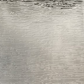 Close-up of Elgin soap pump surface showing silver rippled metallic texture detail.