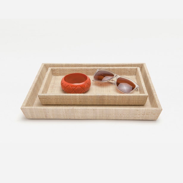 Pigeon & Poodle Ghent nesting tray set in natural raffia, styled with a bracelet and sunglasses.